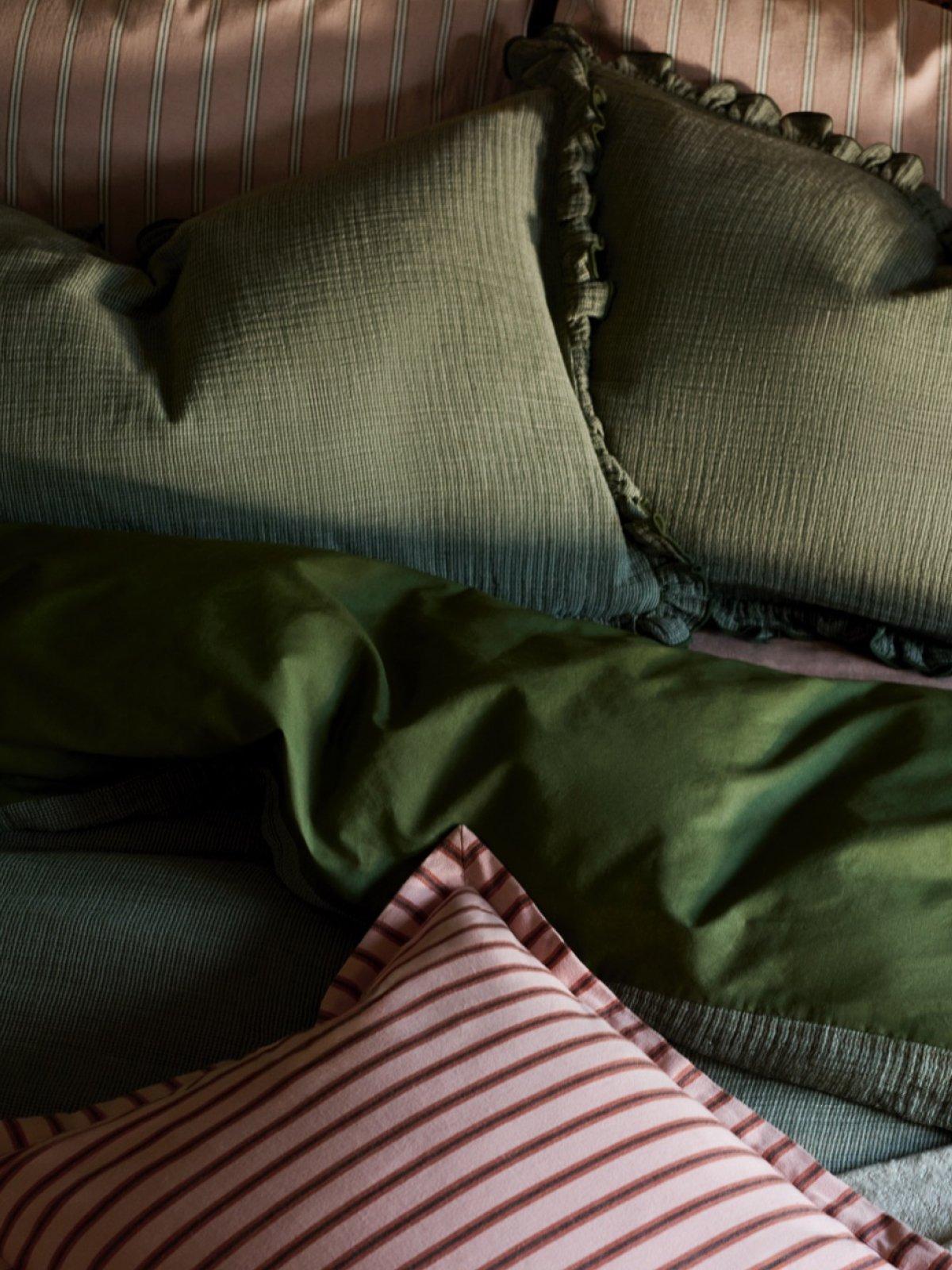 Close-up of various pillows and a duvet