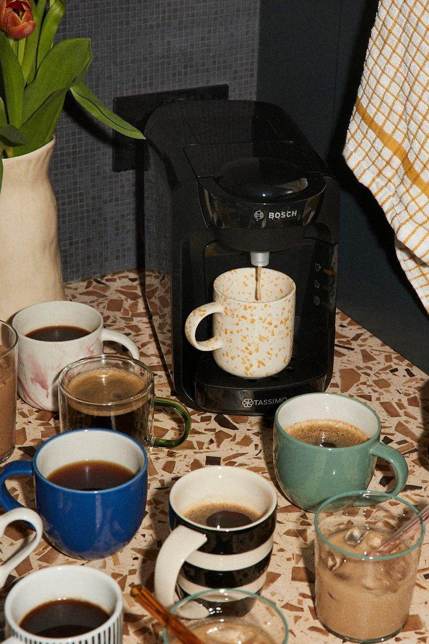 Image of a lots and lots of cups of tea on a table in random mugs