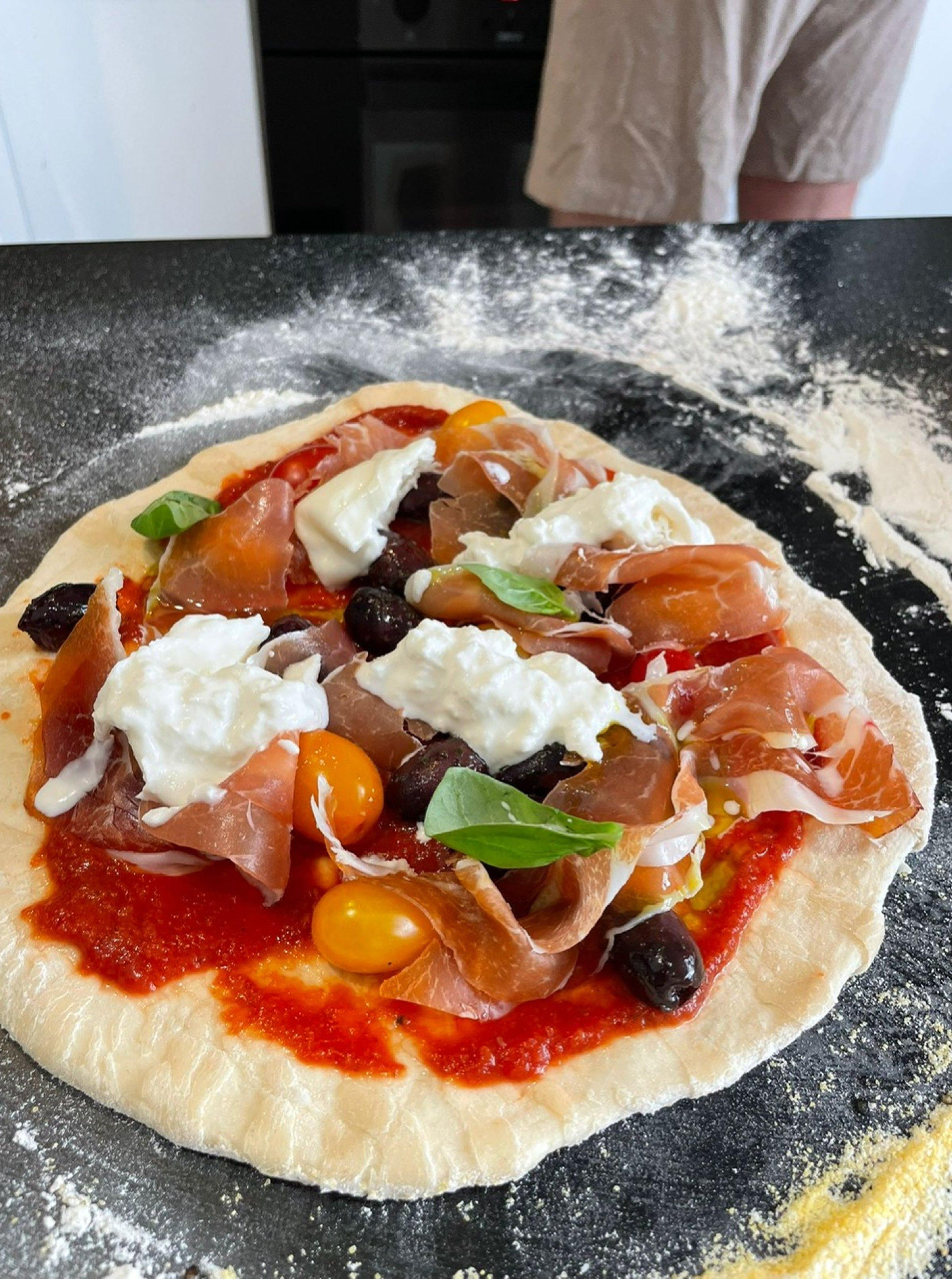 Pizza with various toppings on the table