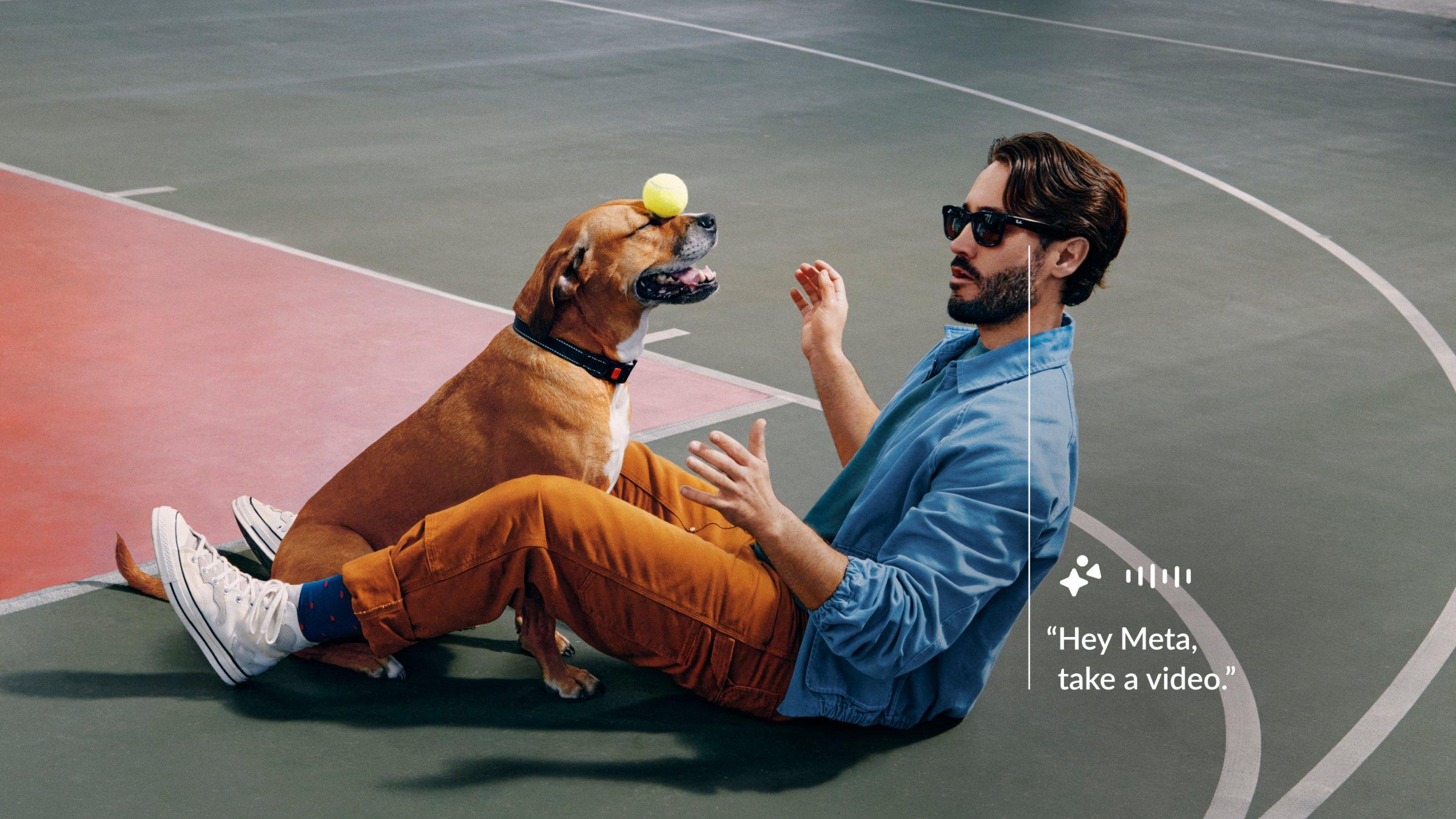 Male model wearing Ray-Ban Meta glasses, playing with a dog that has a tennis ball on its nose