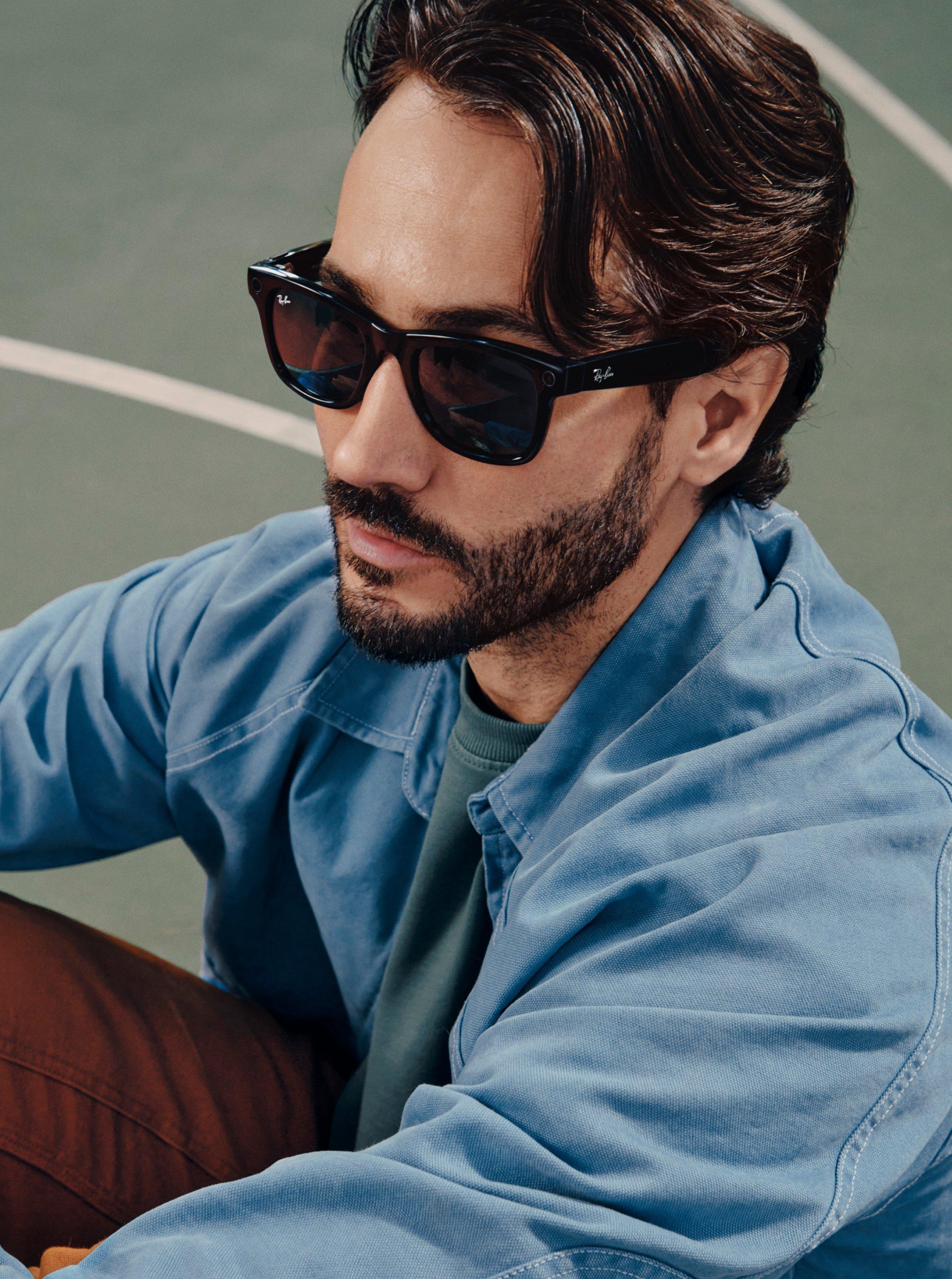 Male model wearing Ray-Ban Meta Glasses on a tennis court