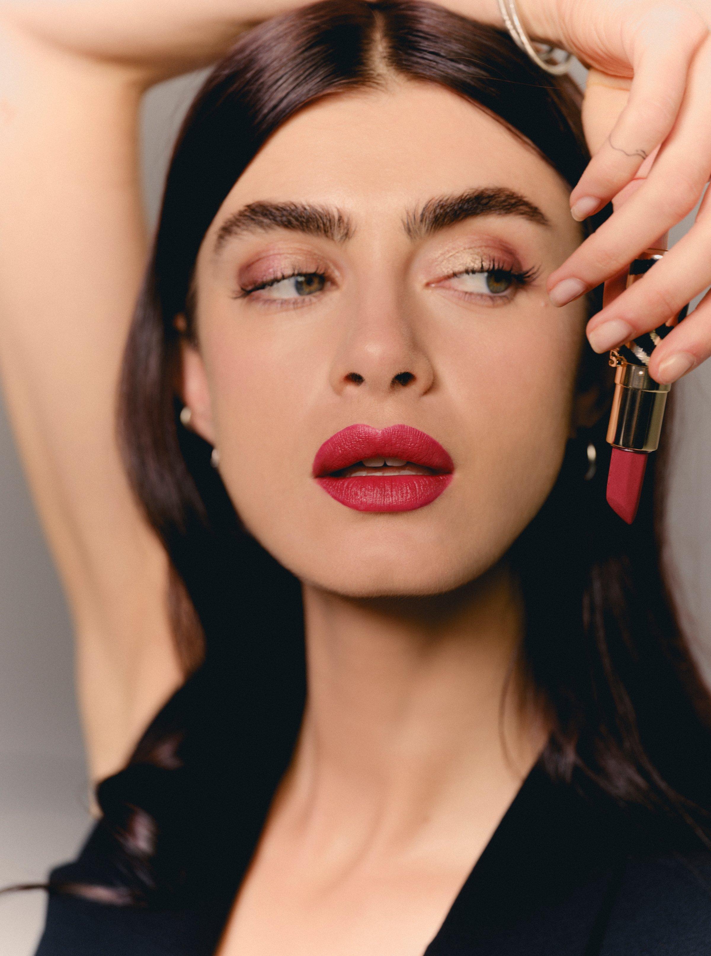 A model wearing deep red Sisley Phyto-Rouge Velvet lipstick