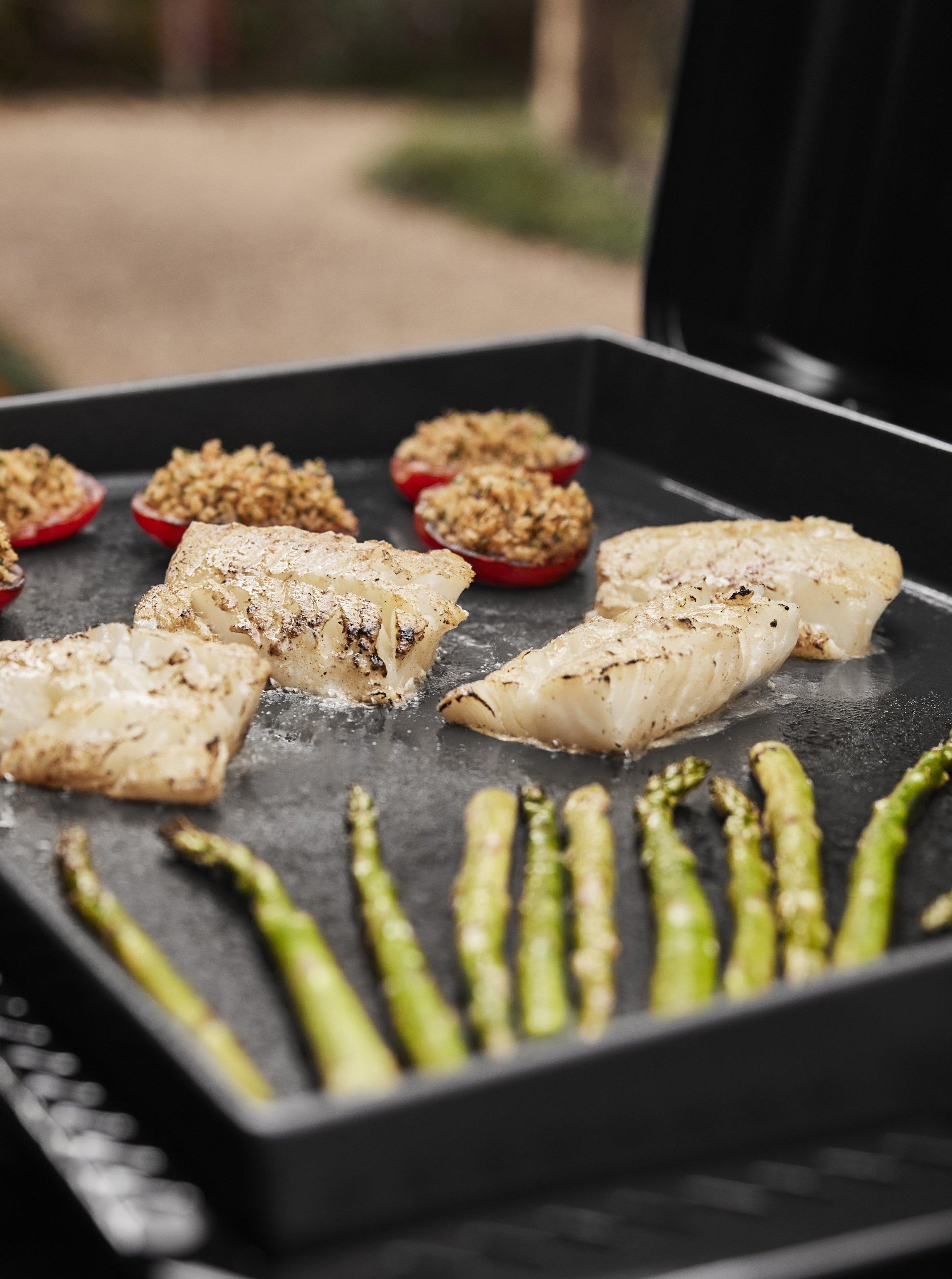 Grilling vegetables and fish on a Weber Slate Premium Griddle GPS6 Gas Grill