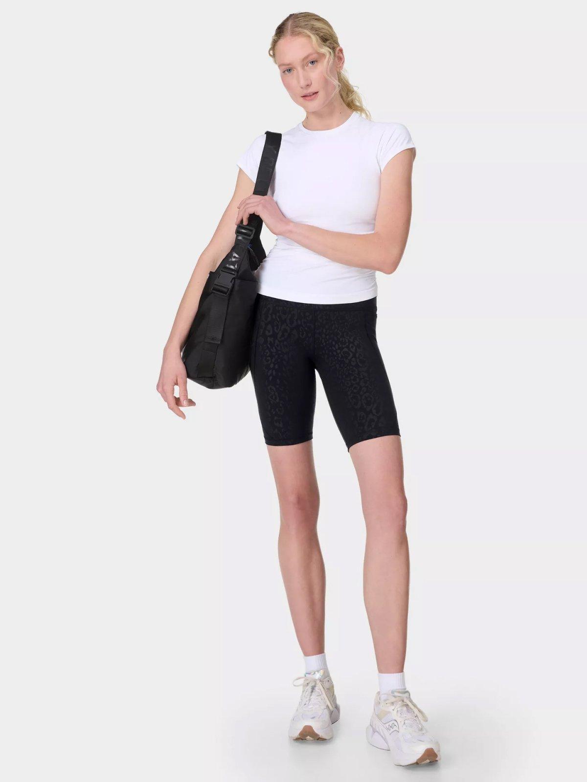 Female model wearing Sweaty Betty Power 9" Biker Shorts