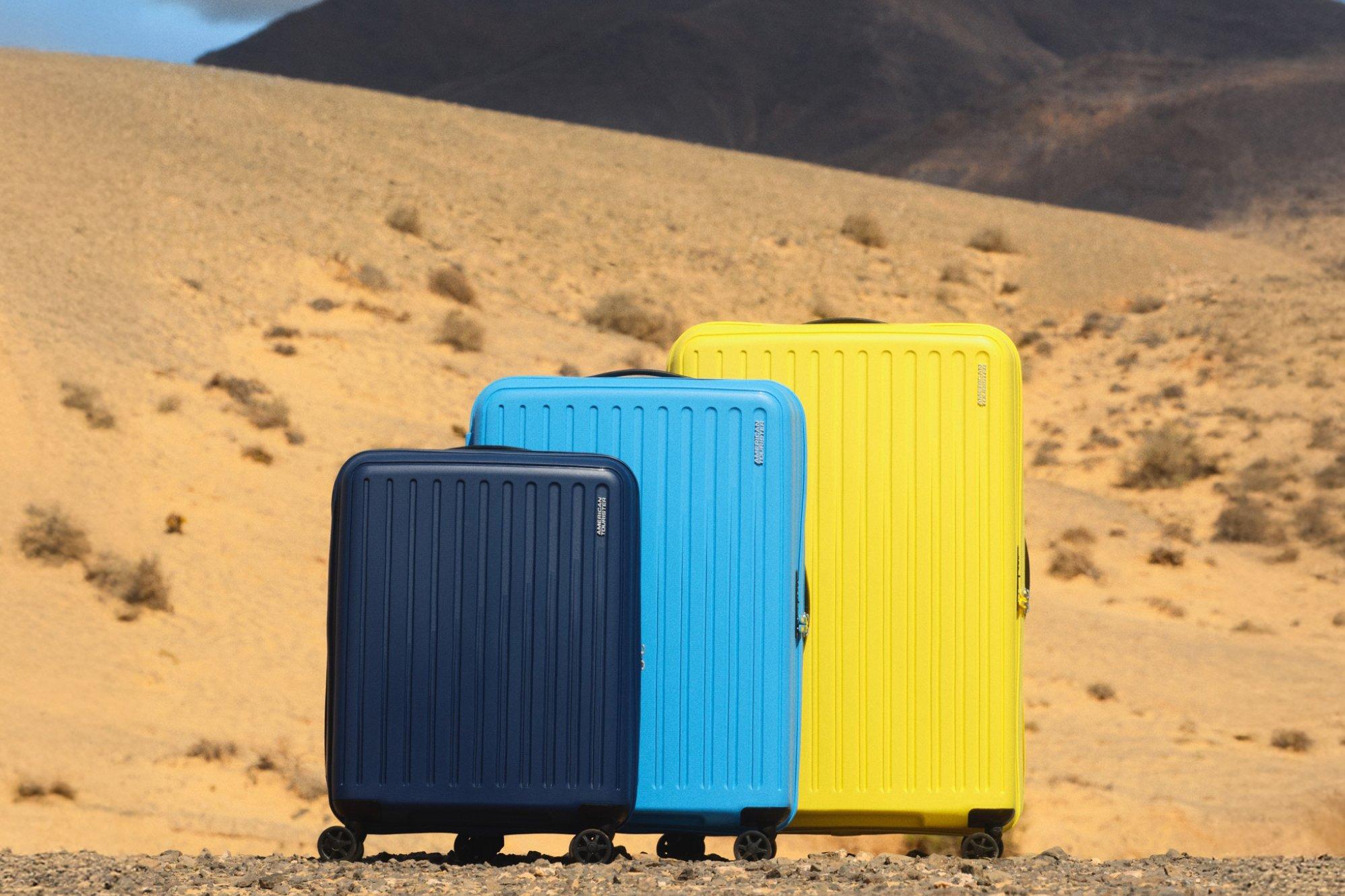 Suitcases of various colours and sizes displayed outdoors