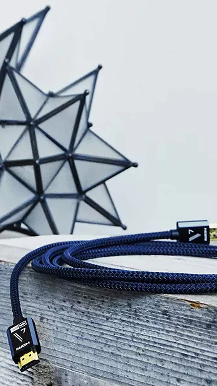 Blue braided HDMI cable on wooden surface with geometric decor, premium high-speed 4K TV connection lead