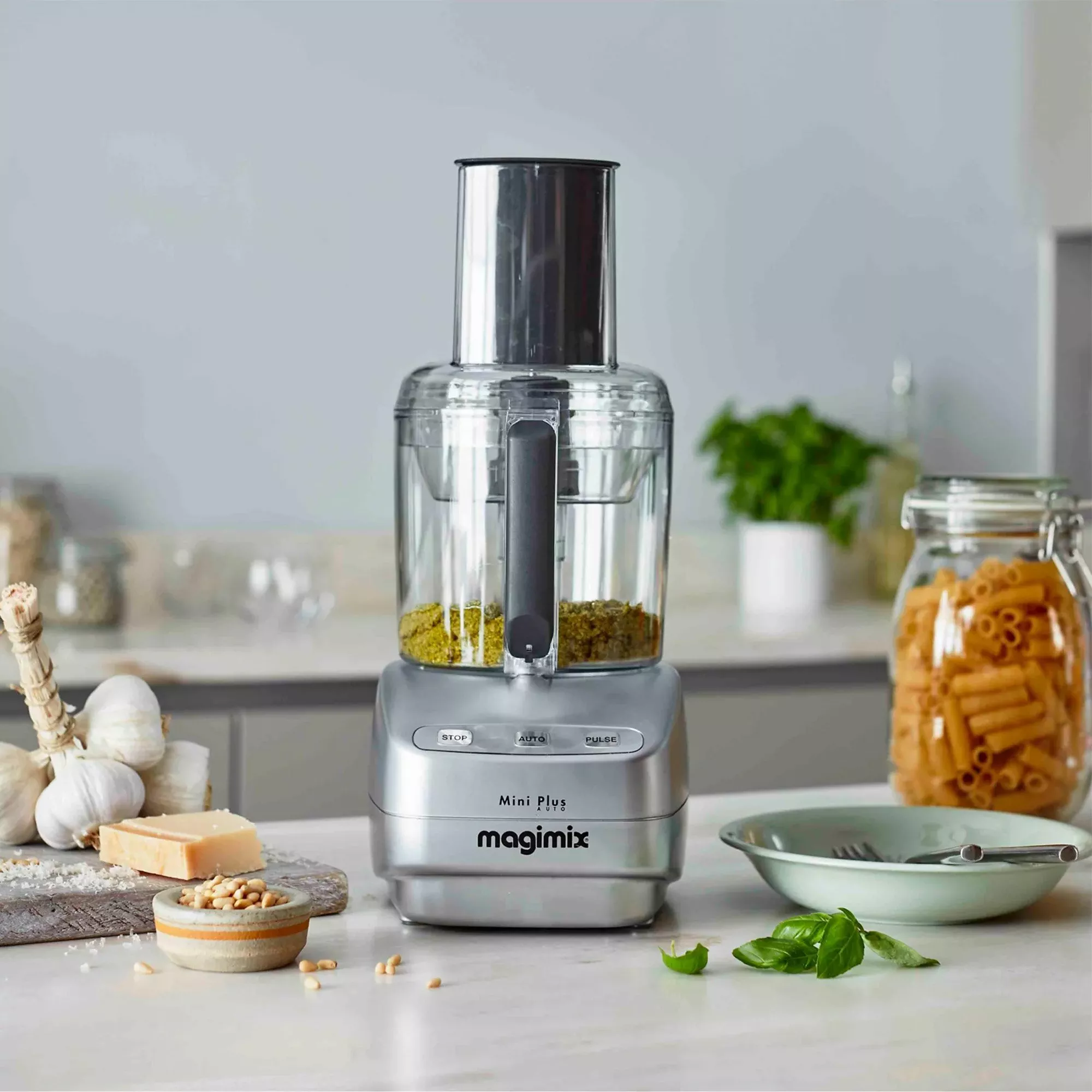 Mini food processor blending up pesto 