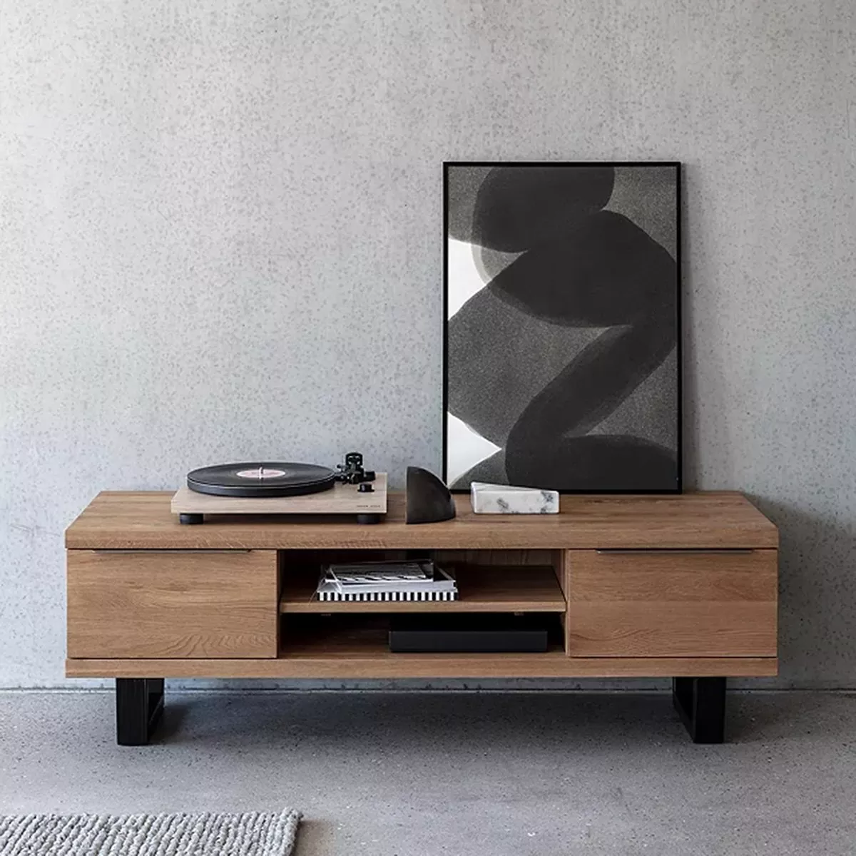Wooden TV stand with record player and artwork on top