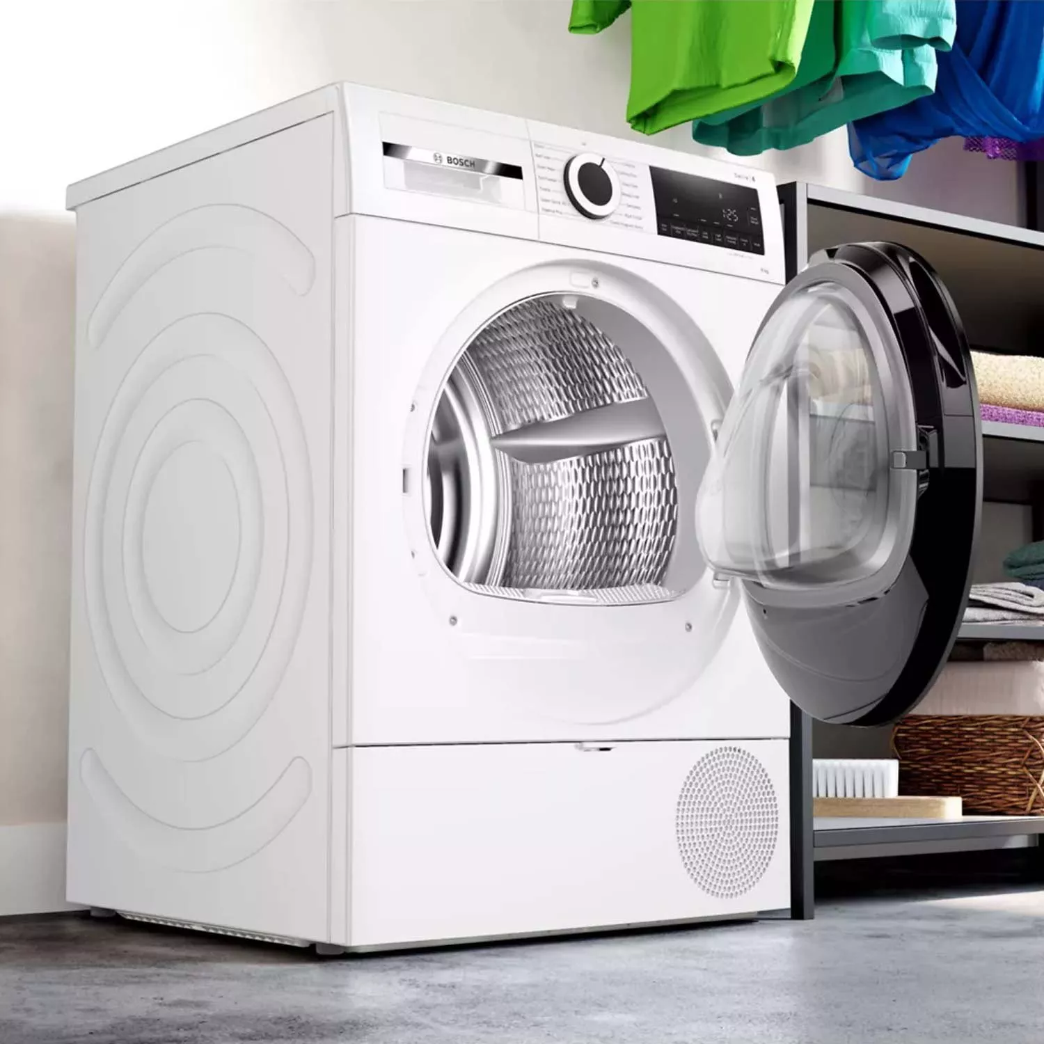 White Bosch tumble dryer with open door in modern laundry room, showing drum and digital control panel