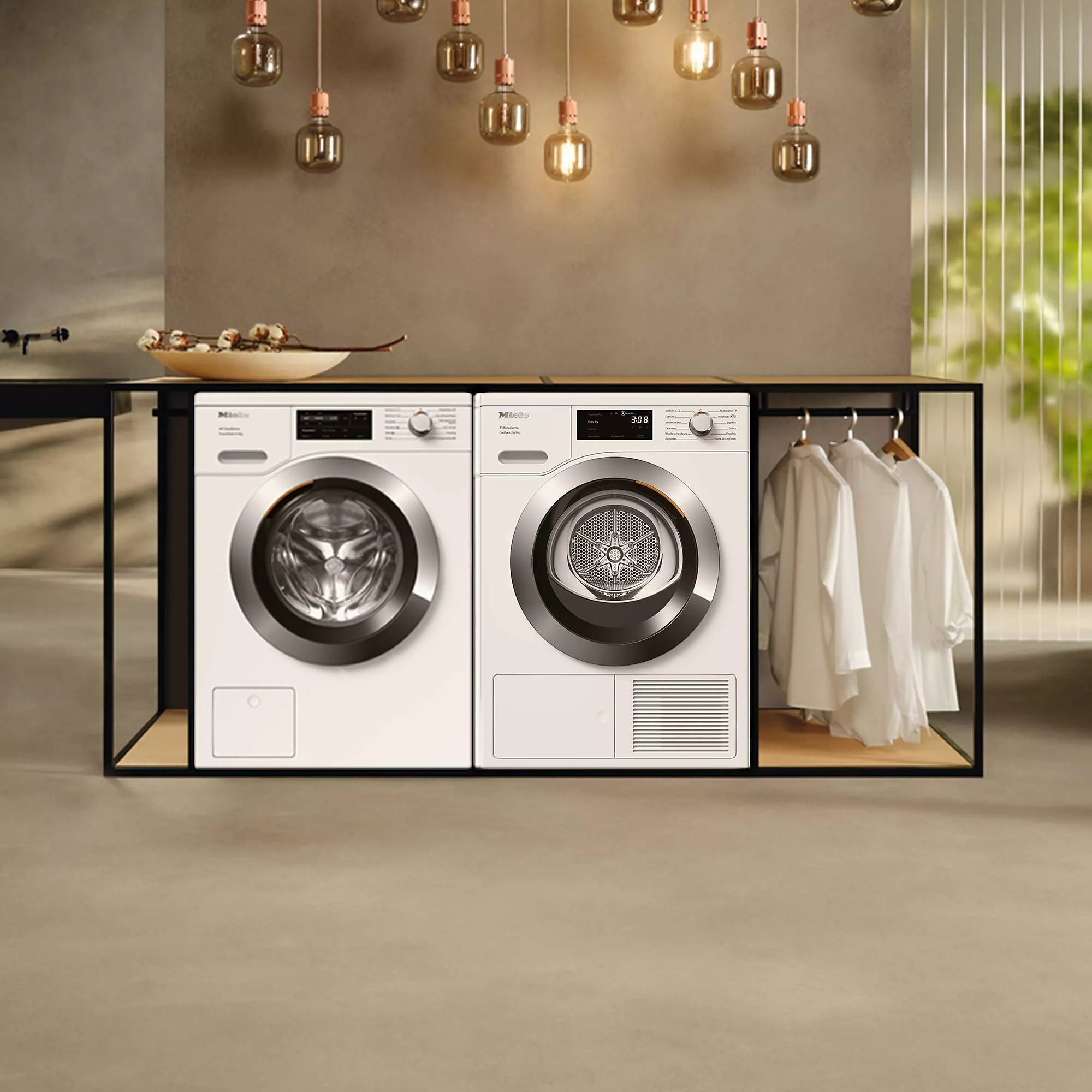 Modern utility room with integrated washing machine and tumble dryer, pendant lighting and shirts on hangers