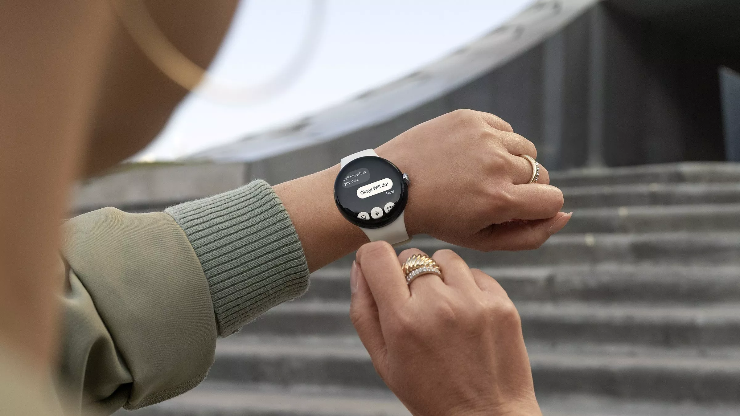 A woman receiving a text on her smartwatch while out
