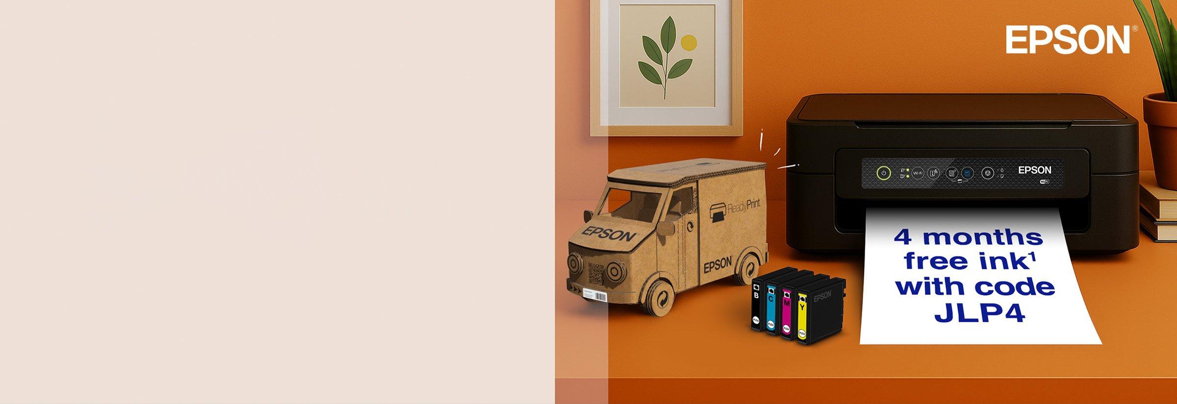 Epson pronter on an orange desk next to a cardboard truck, books, and a full colour ink cartridge.