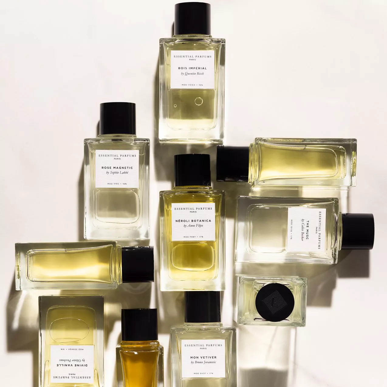 A collection of Essential Parfums bottles arranged stylishly on a light background, showcasing diverse fragrances.