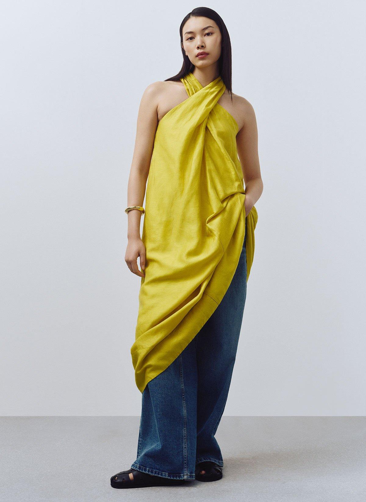 Model wearing chartreuse halterneck linen dress