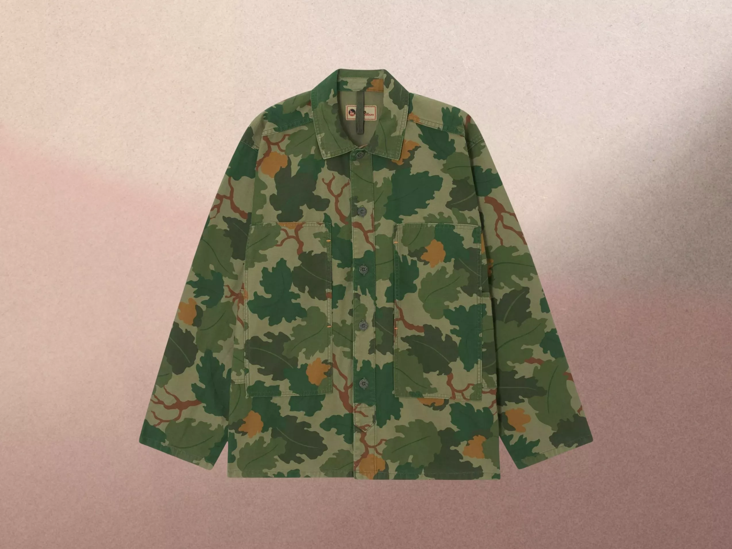 Camouflage jacket with leaf pattern on a textured background, featuring front pockets and button closure.