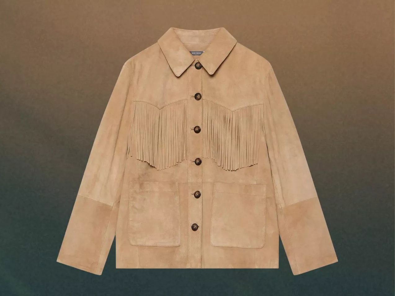 Tan suede fringe jacket with button front, large patch pockets and western yoke, against gradient neutral  background