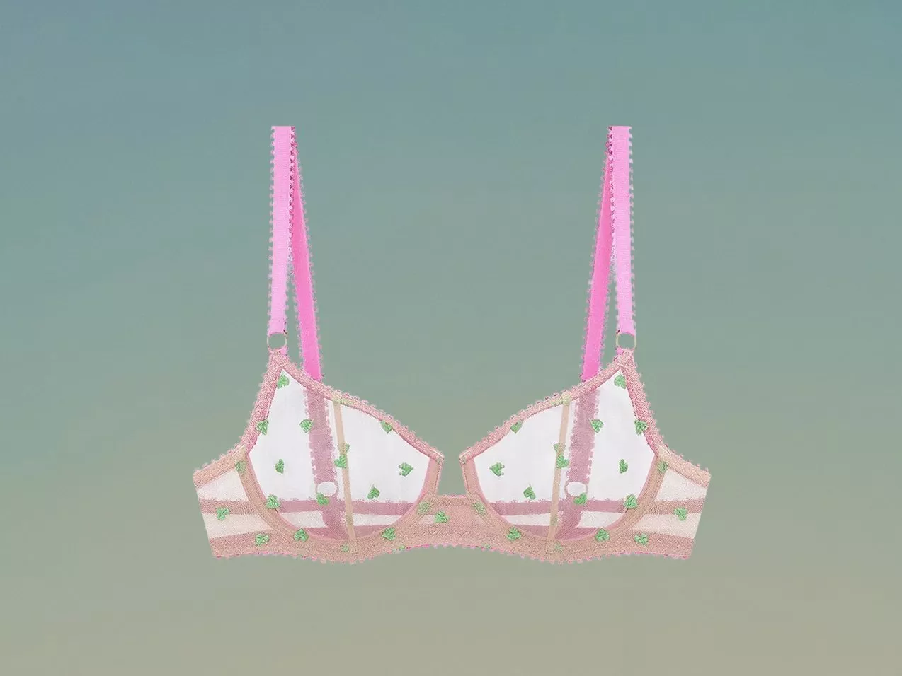 Pink and white sheer mesh bra with green heart embroidery and adjustable straps on a soft green background