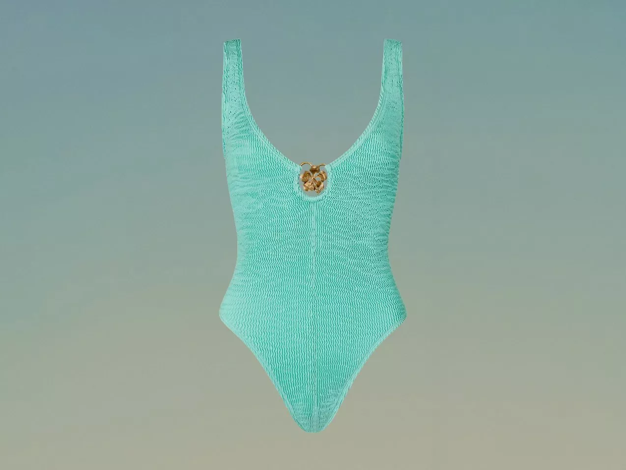 Textured aqua one-piece swimsuit with deep scoop neckline and gold detail, on green gradient backdrop