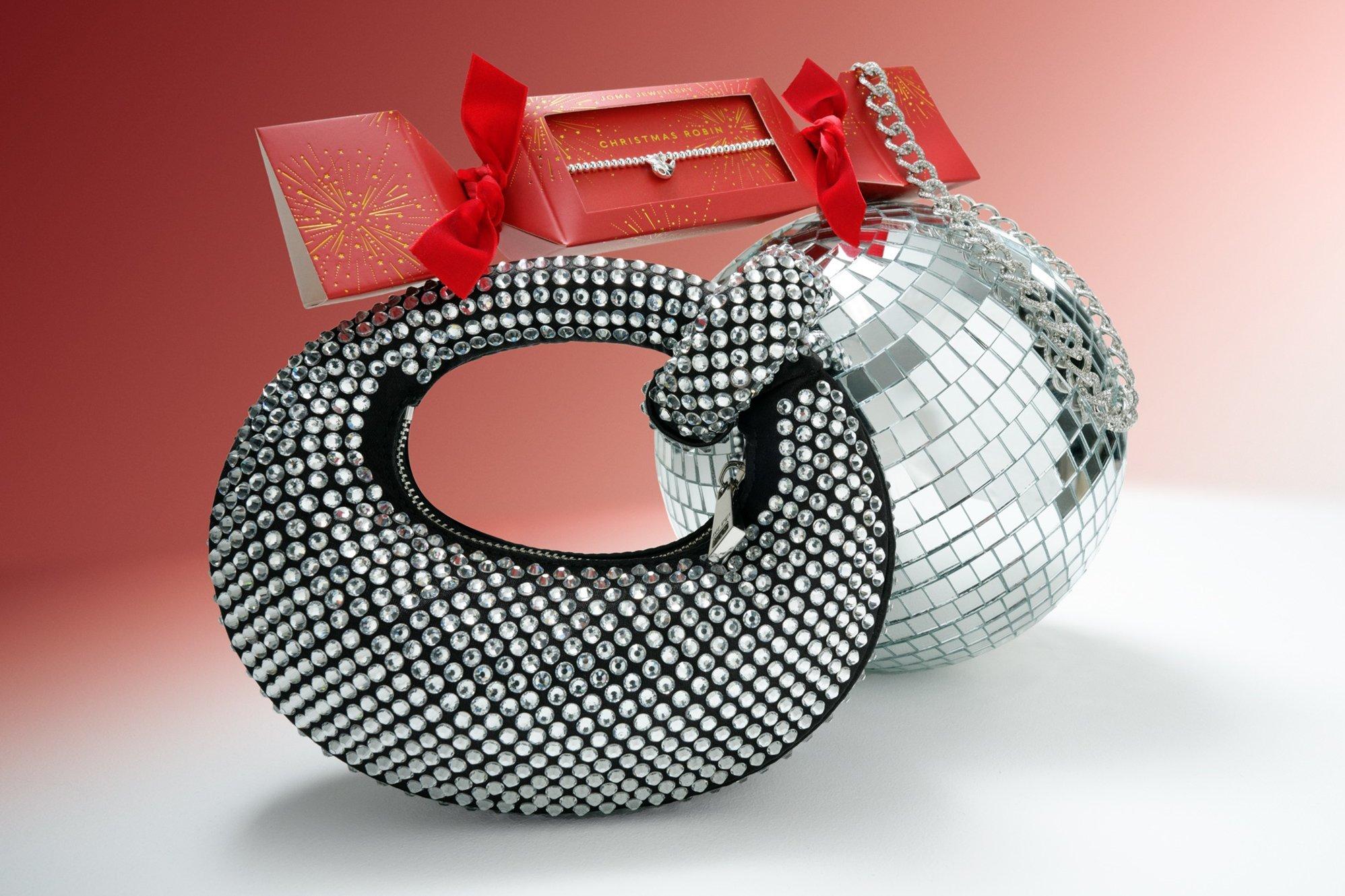 Diamond handbag and jewellery next to disco ball