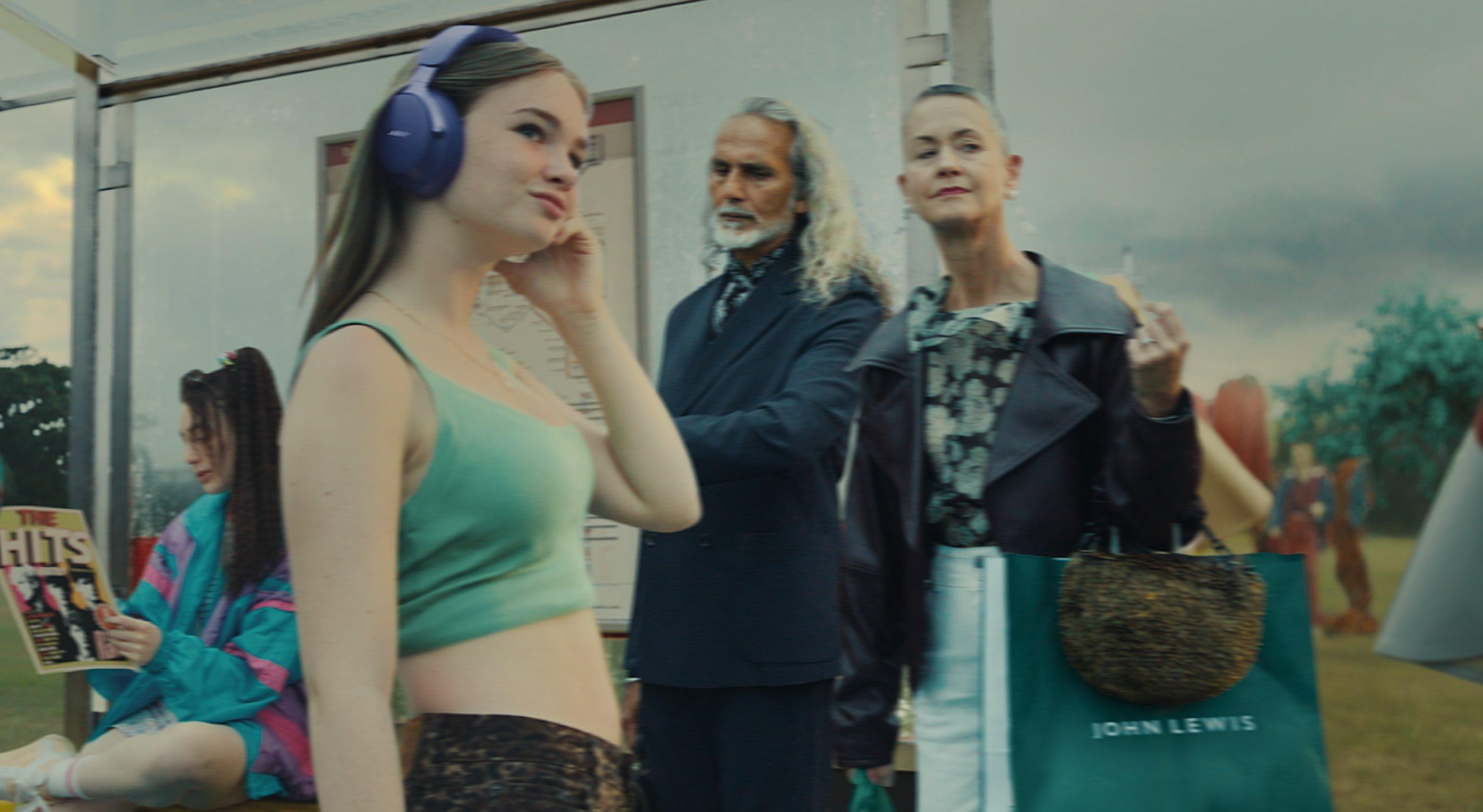 Image of our new tv ad with a man in a Paul Smith suit and woman waiting at the bus stop
