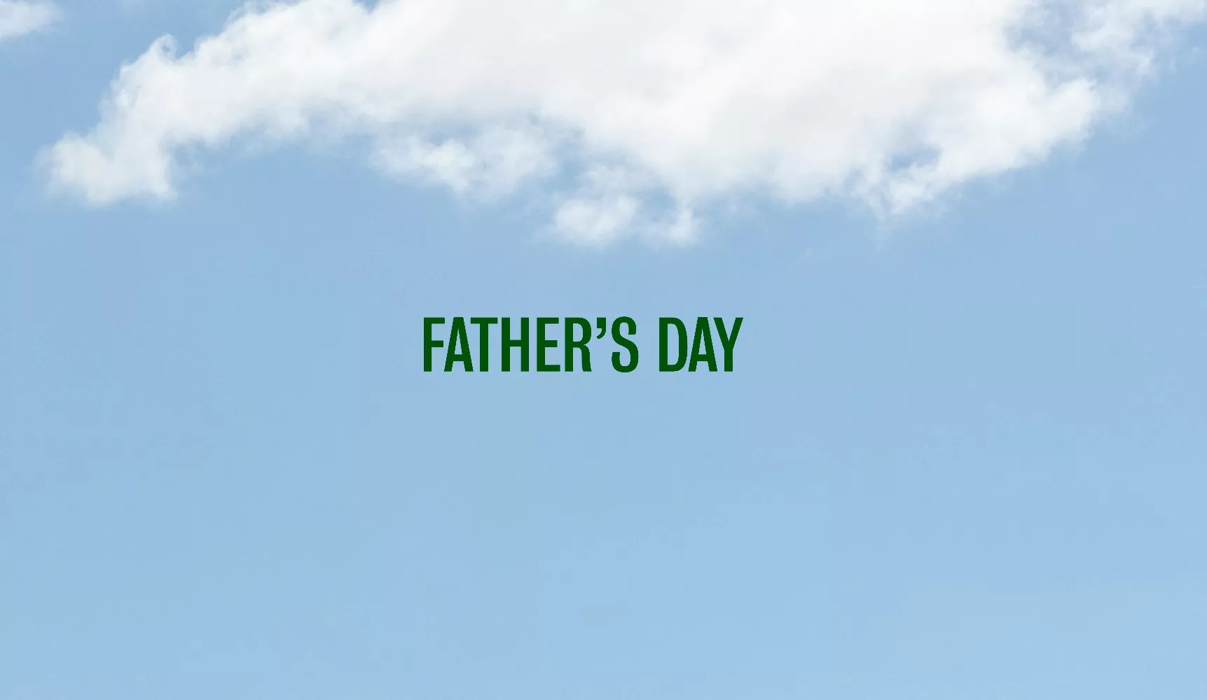 Father’s Day greeting banner with green text on a blue sky background with soft white clouds, minimalist design