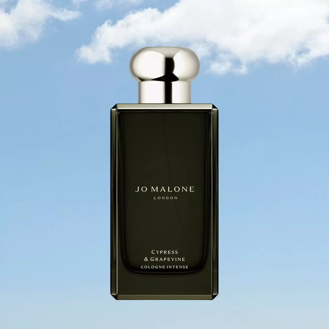 Jo Malone London Cypress & Grapevine Cologne Intense bottle, dark green glass with silver cap on sky background