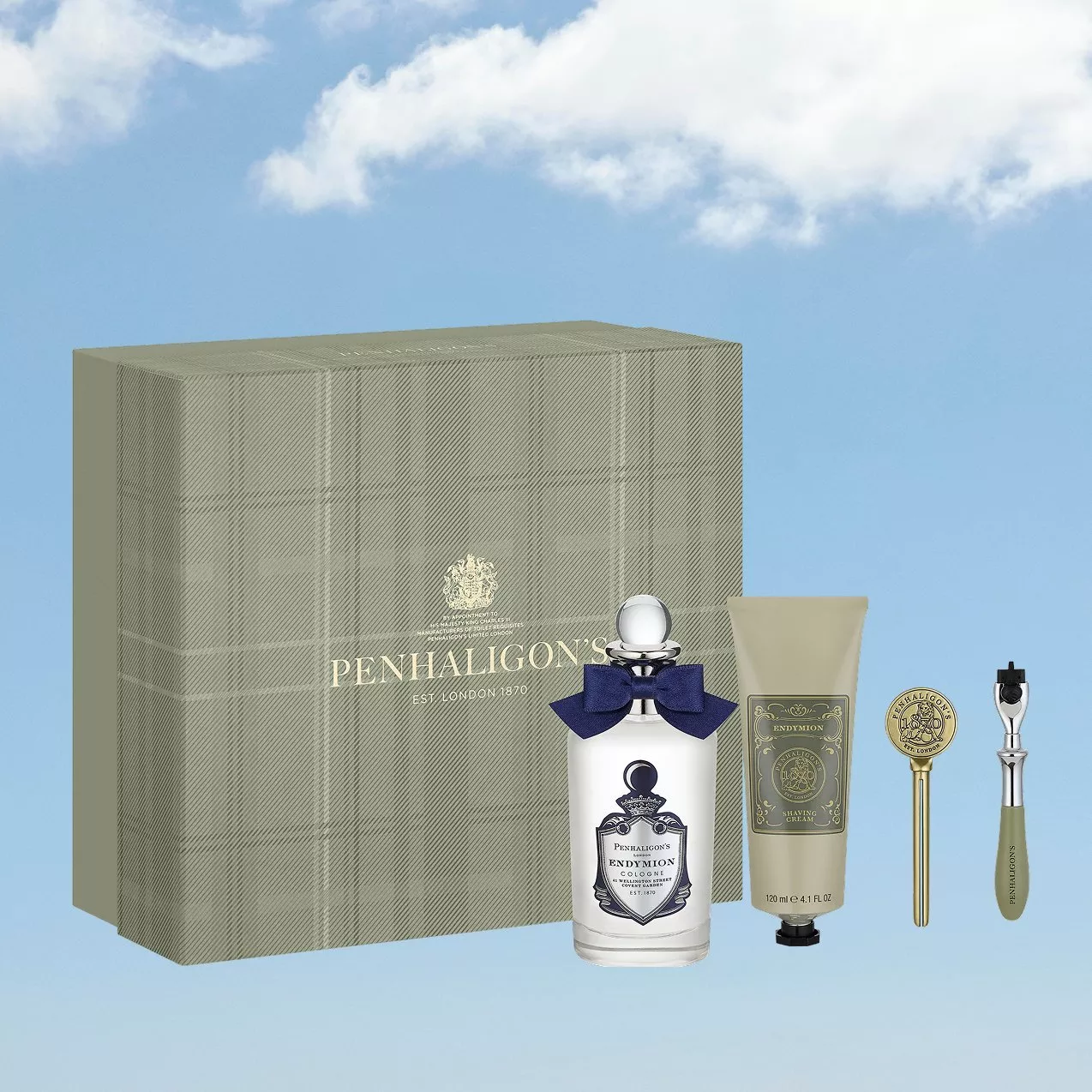 Penhaligon’s Endymion men’s fragrance gift set with cologne, shaving cream, razor and box on blue sky background