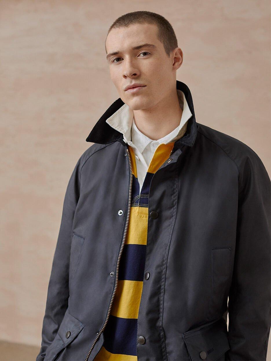 Model in striped polo shirt and jacket