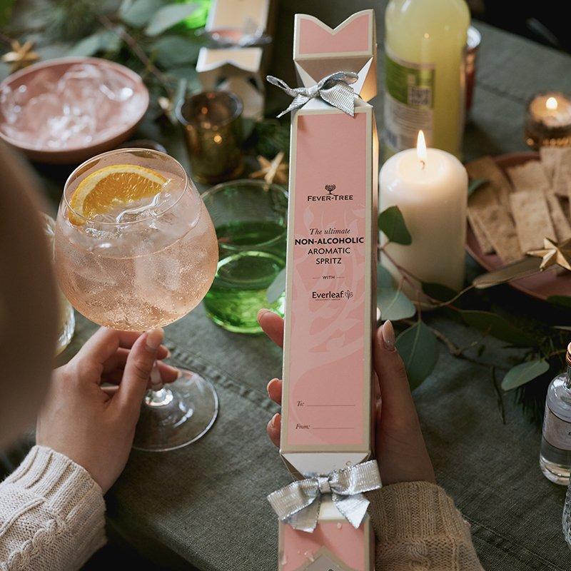 Non-alcoholic spritz cracker next to glass of spritz