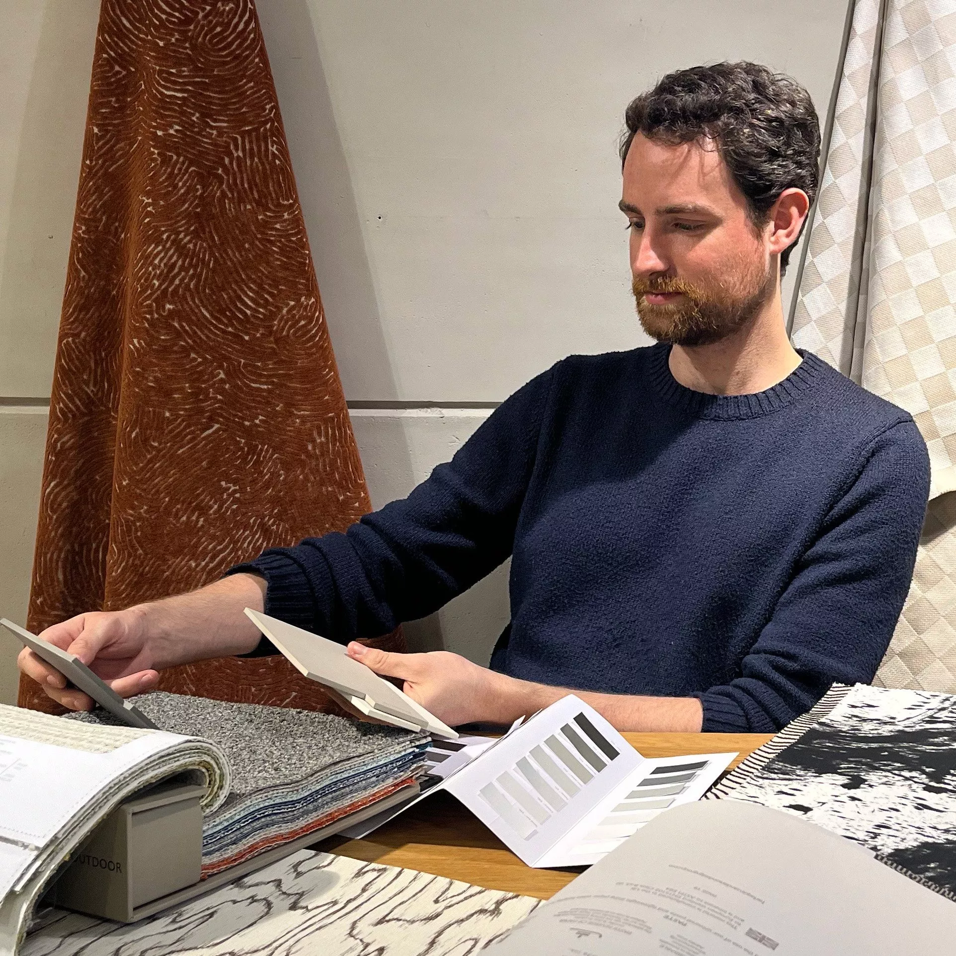 man reviewing material swatches