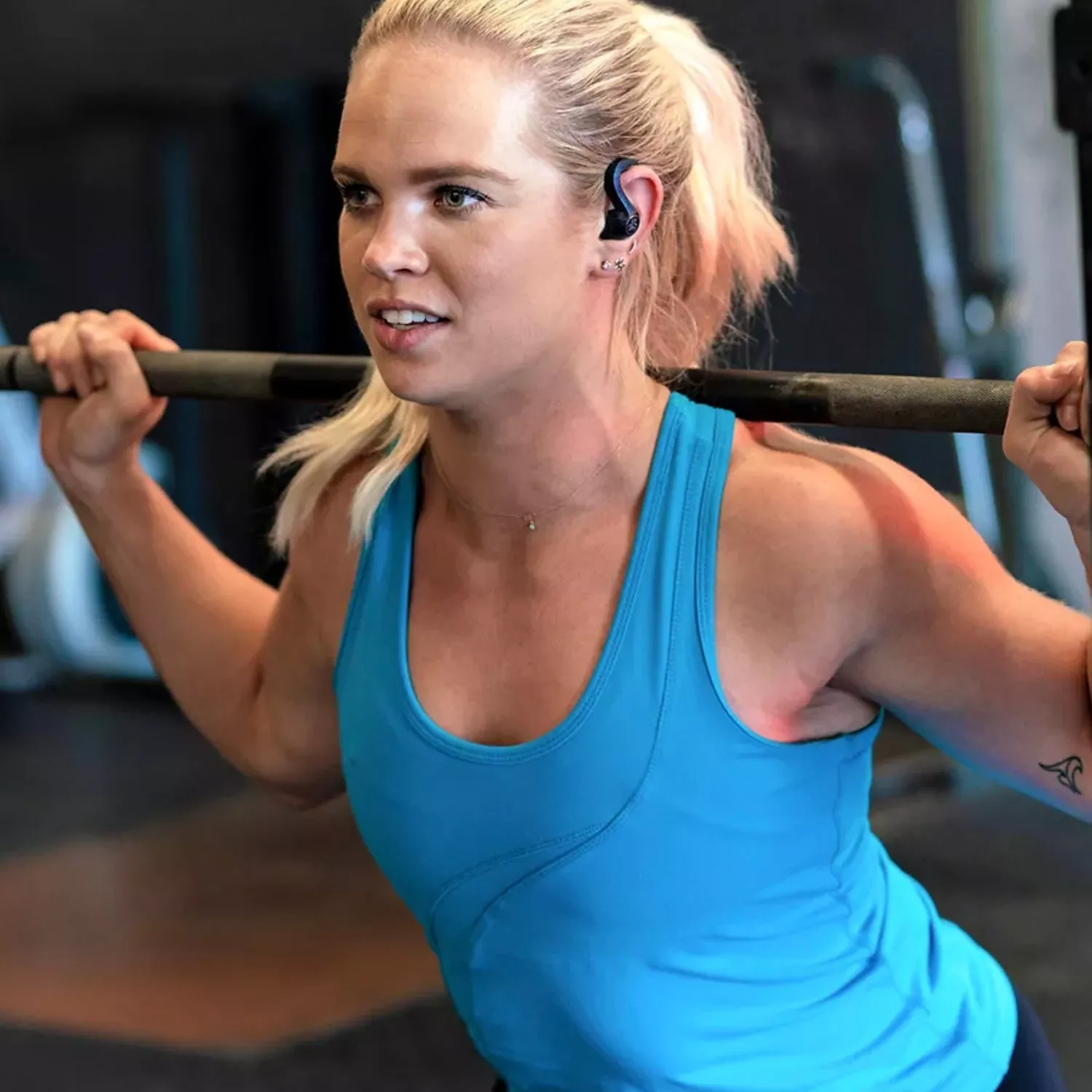 women exercising with in ear headphones