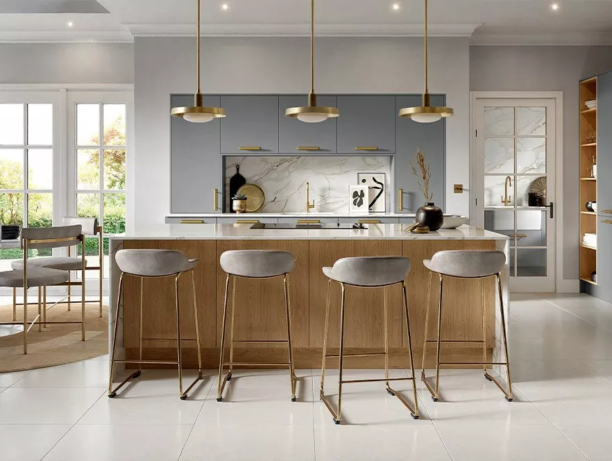 Kitchen setting with grey cabinets and four bar stools