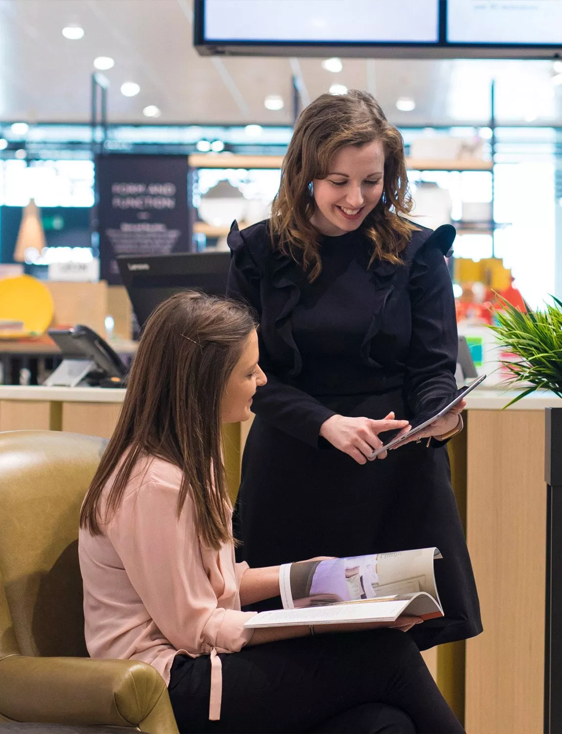 Two people looking through a brochure