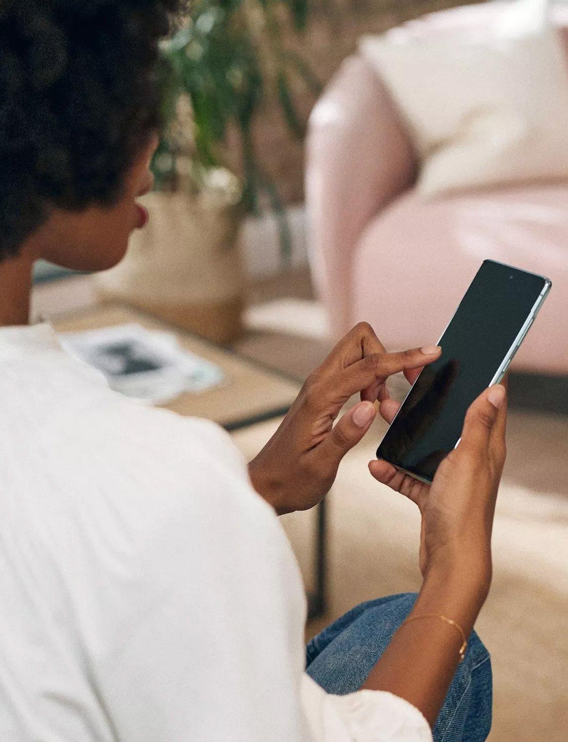 Woman holding a smart phone while looking at the screen