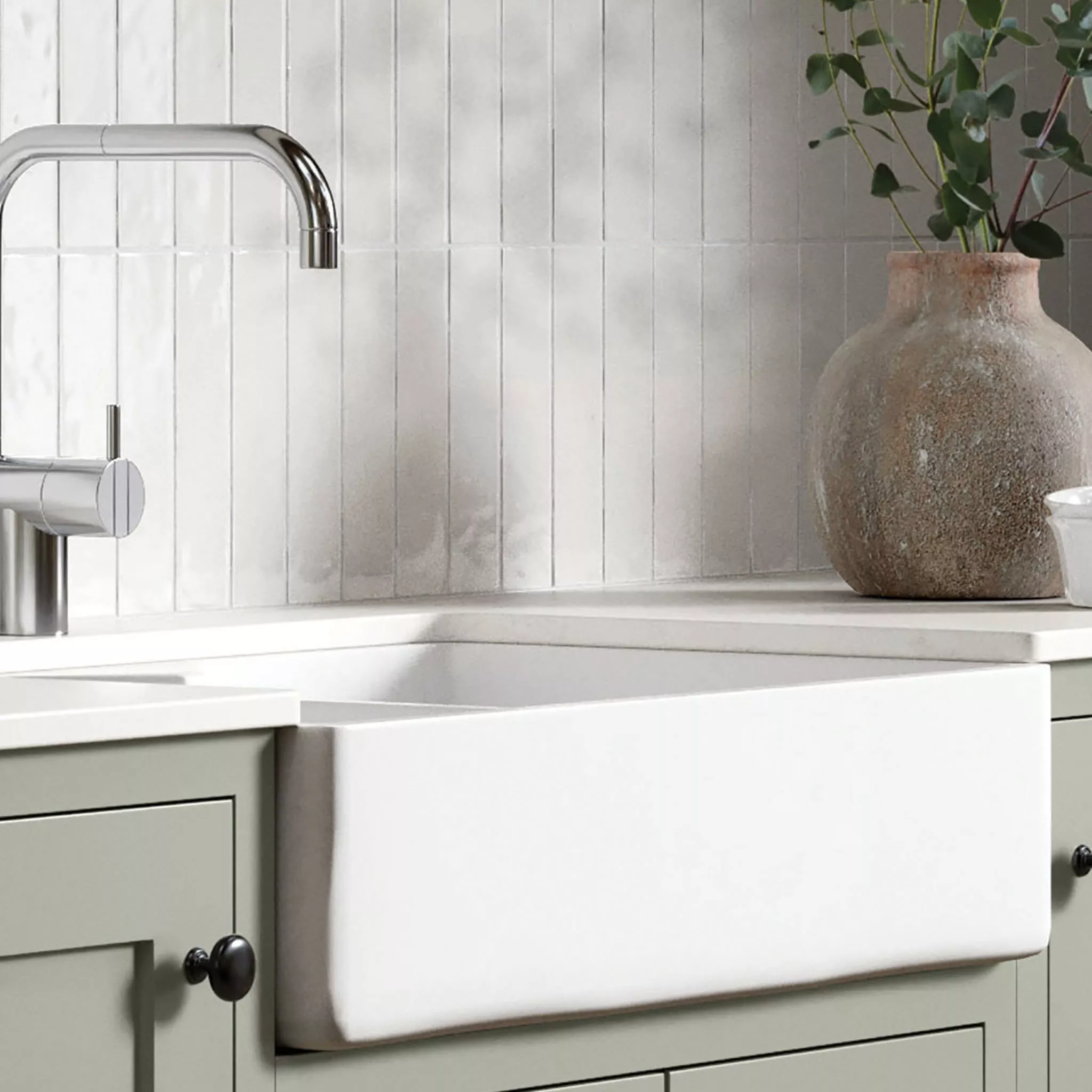White kitchen sink with silver tap