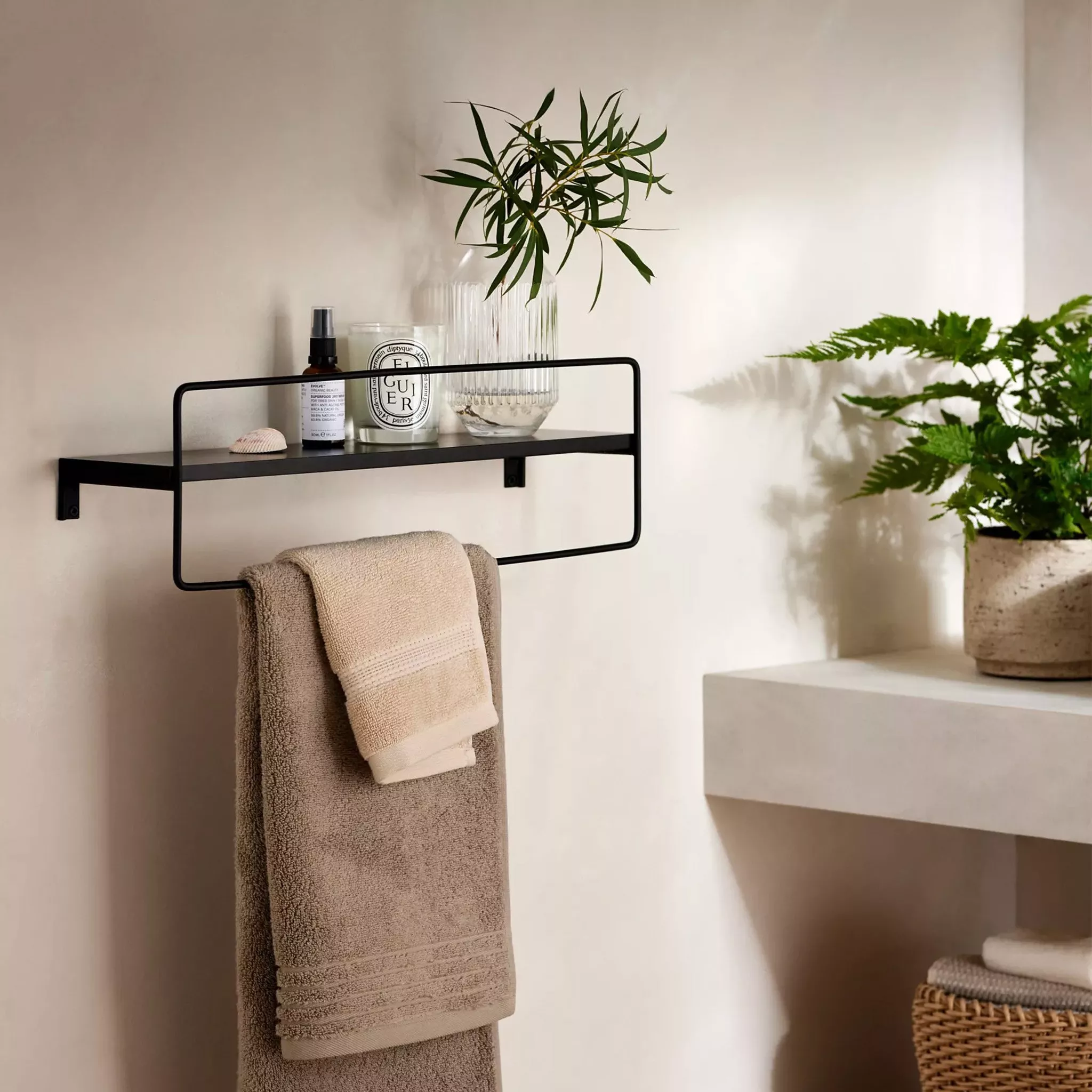 Black metal shelf with built in towel rack 