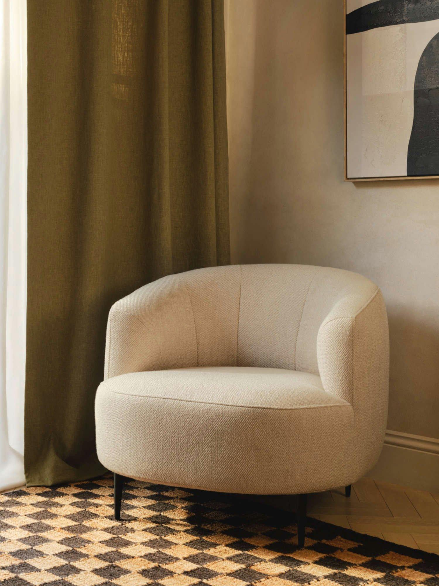 White boule armchair and footstool in a neutral room