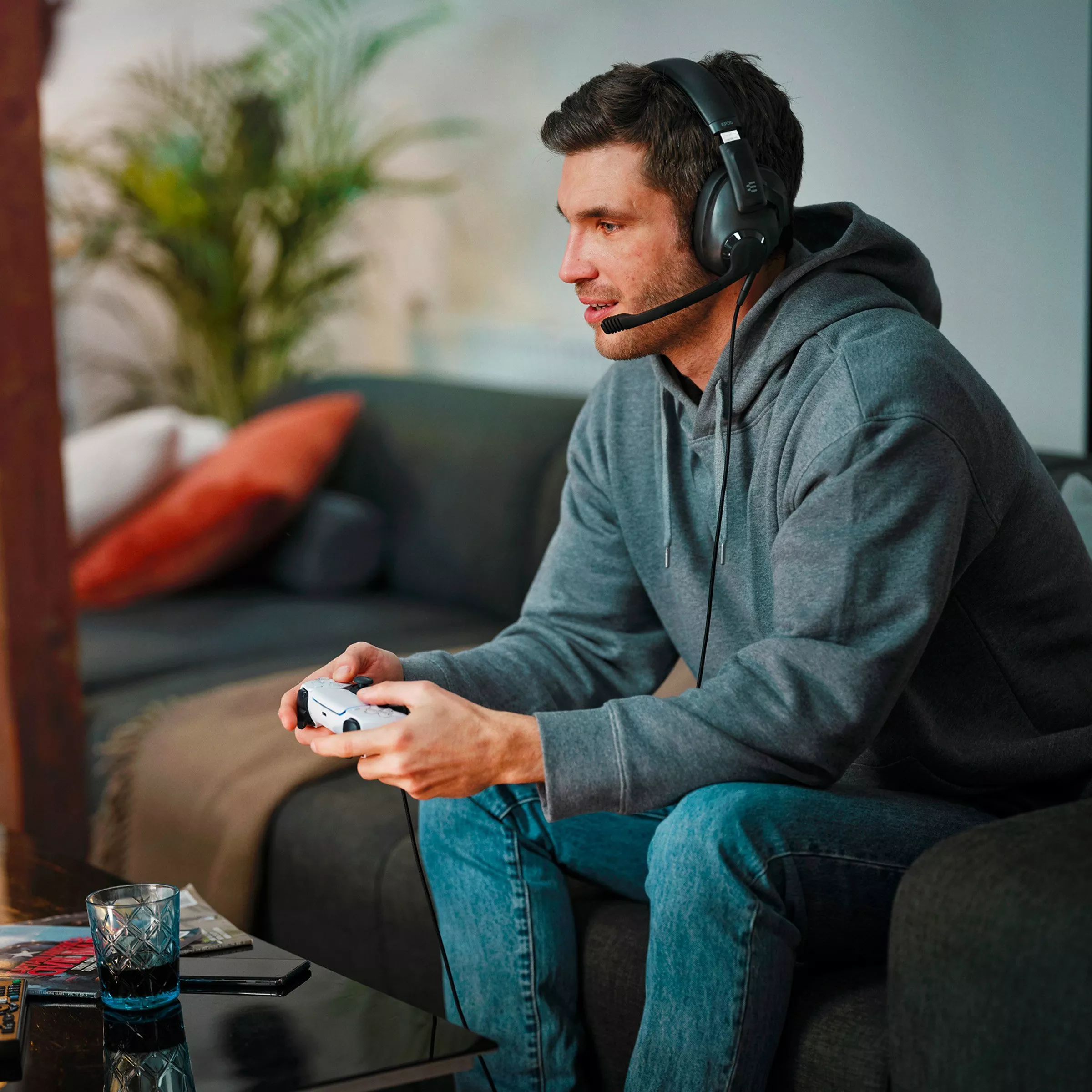 Person using a games controller and gaming headset