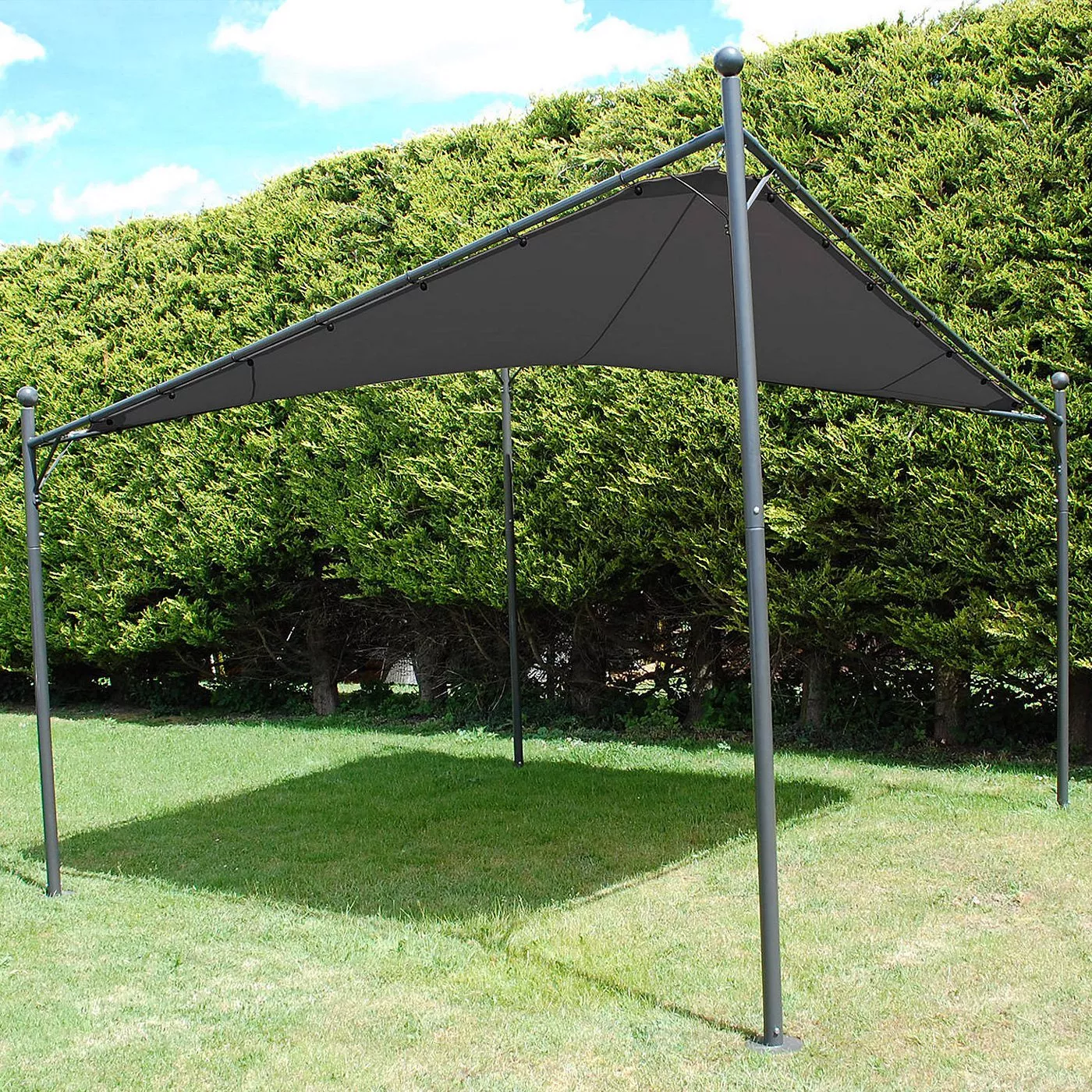 Grey metal garden gazebo with triangular canopy providing shade on lawn, set against tall green hedges.