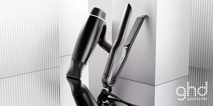 Modern black hairdryer and hair straighteners set in minimalist studio, professional hair styling tools display