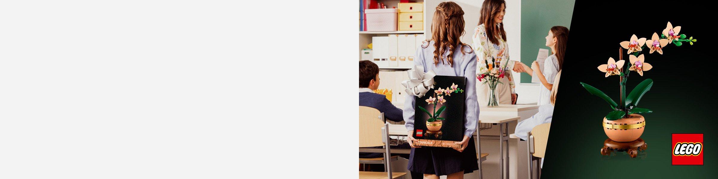 Girl at school standing in front of her teacher while holding Botanicals Mini Orchid Faux Plant Set behind her back as a surpise gift.