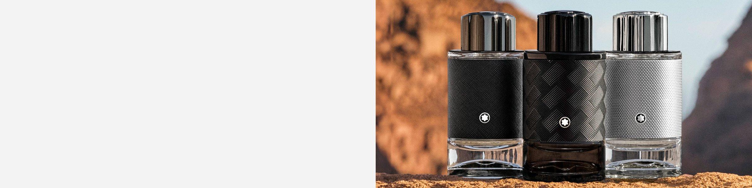 Three Montblanc Explorer Extreme Parfum fragrance bottles on a rocky edge