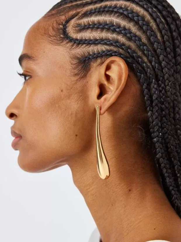 woman wearing gold drop earring