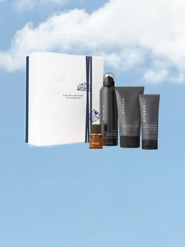 Rituals men’s grooming gift set with boxed packaging, shower foam, face scrub and shampoo on blue sky background