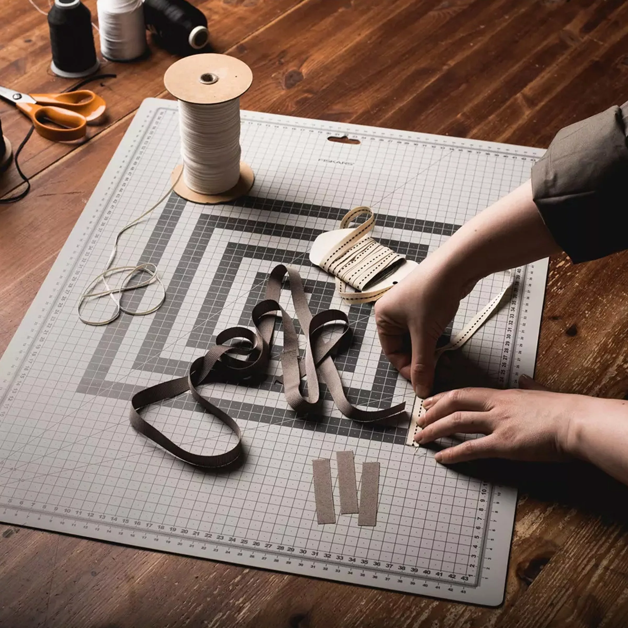 Cutting mat with a person measuring ribbon against it