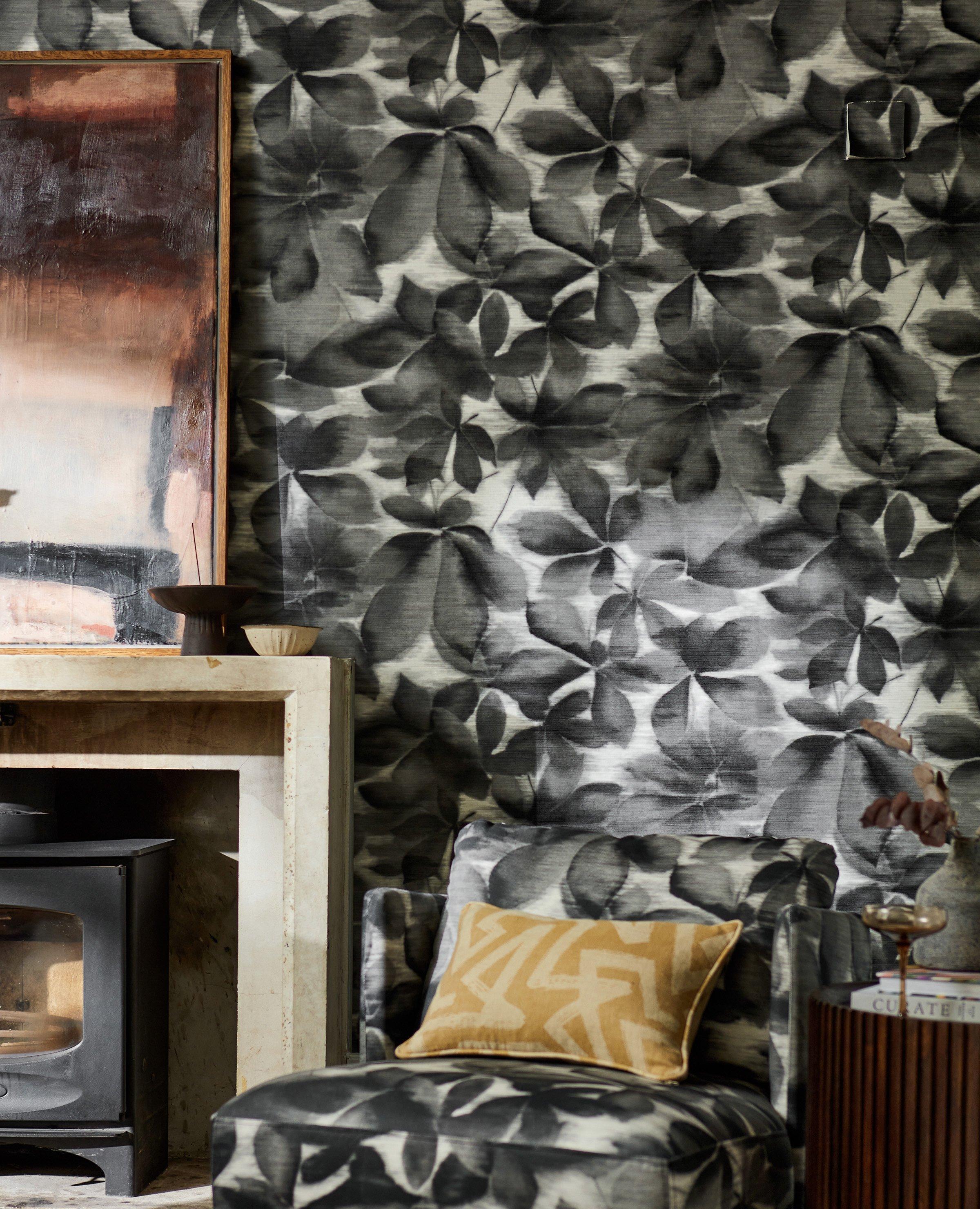 Harlequin black and white wallpaper shot in a lounge next to a fireplace