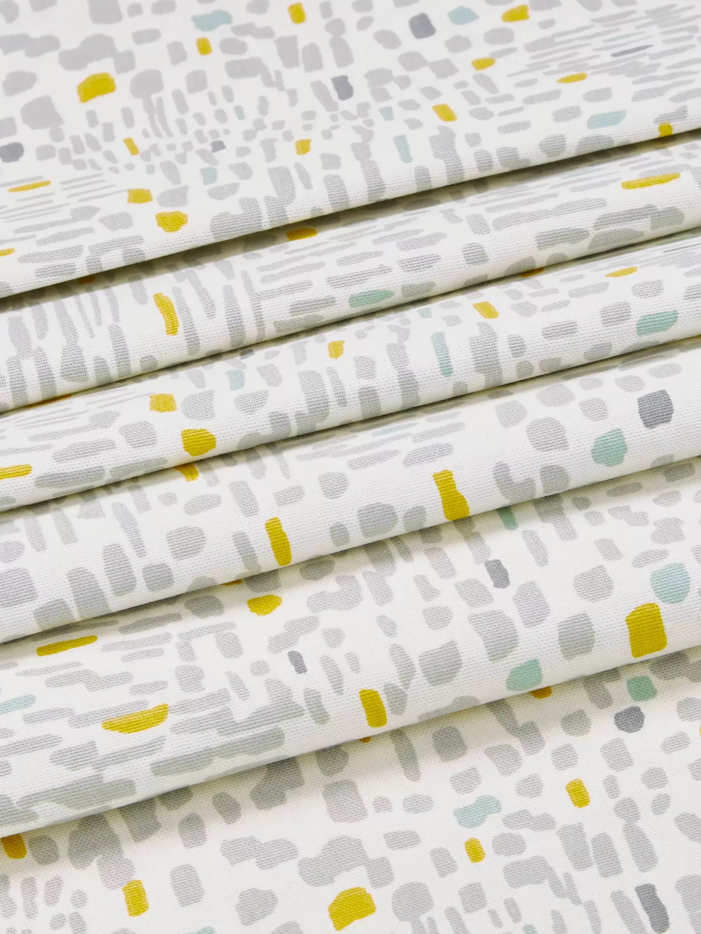 Grey and yellow spotted fabrics