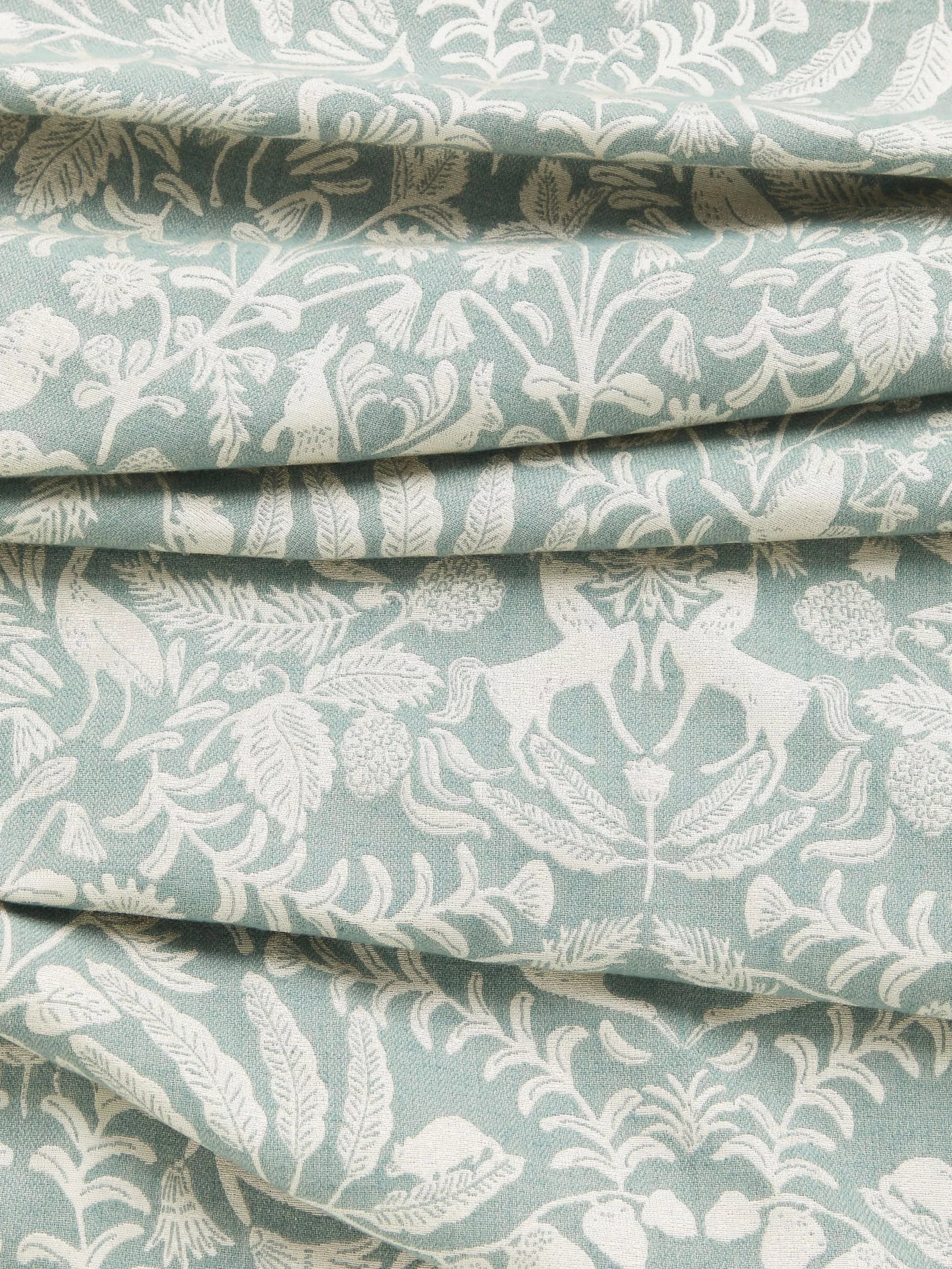 Fabric with light blue background and white floral pattern