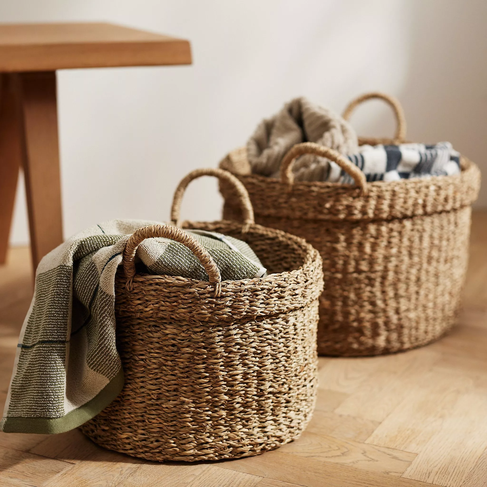 Two wicker baskets filled with blankets 