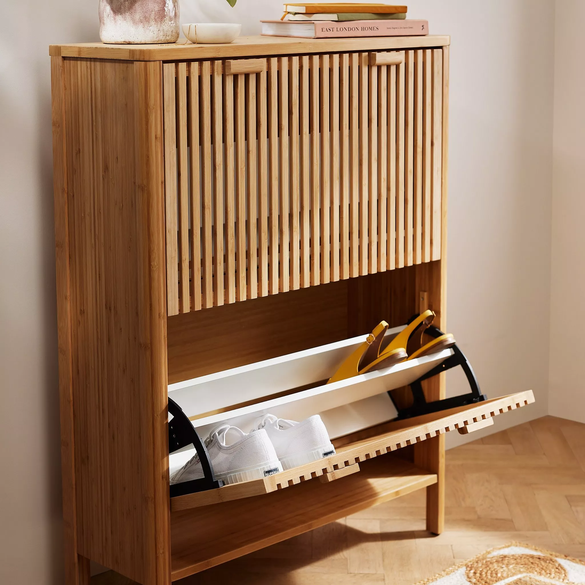 Wooden shoe cabinet with trainers and sandals inside